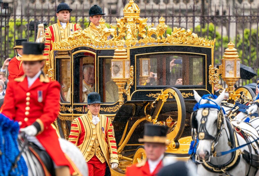 LONDON, ENGLAND - MAY 06: King Charles III and Camilla, Queen Consort are carried in the Diamond Jubilee State Coach as the King's procession passes Parliament Square ahead of the Coronation at Westminster Abbey on May 6, 2023 in London, England. The Coronation of Charles III and his wife, Camilla, as King and Queen of the United Kingdom of Great Britain and Northern Ireland, and the other Commonwealth realms takes place at Westminster Abbey today. Charles acceded to the throne on 8 September 2022, upon the death of his mother, Elizabeth II. (Photo by Jane Barlow - WPA Pool/Getty Images)