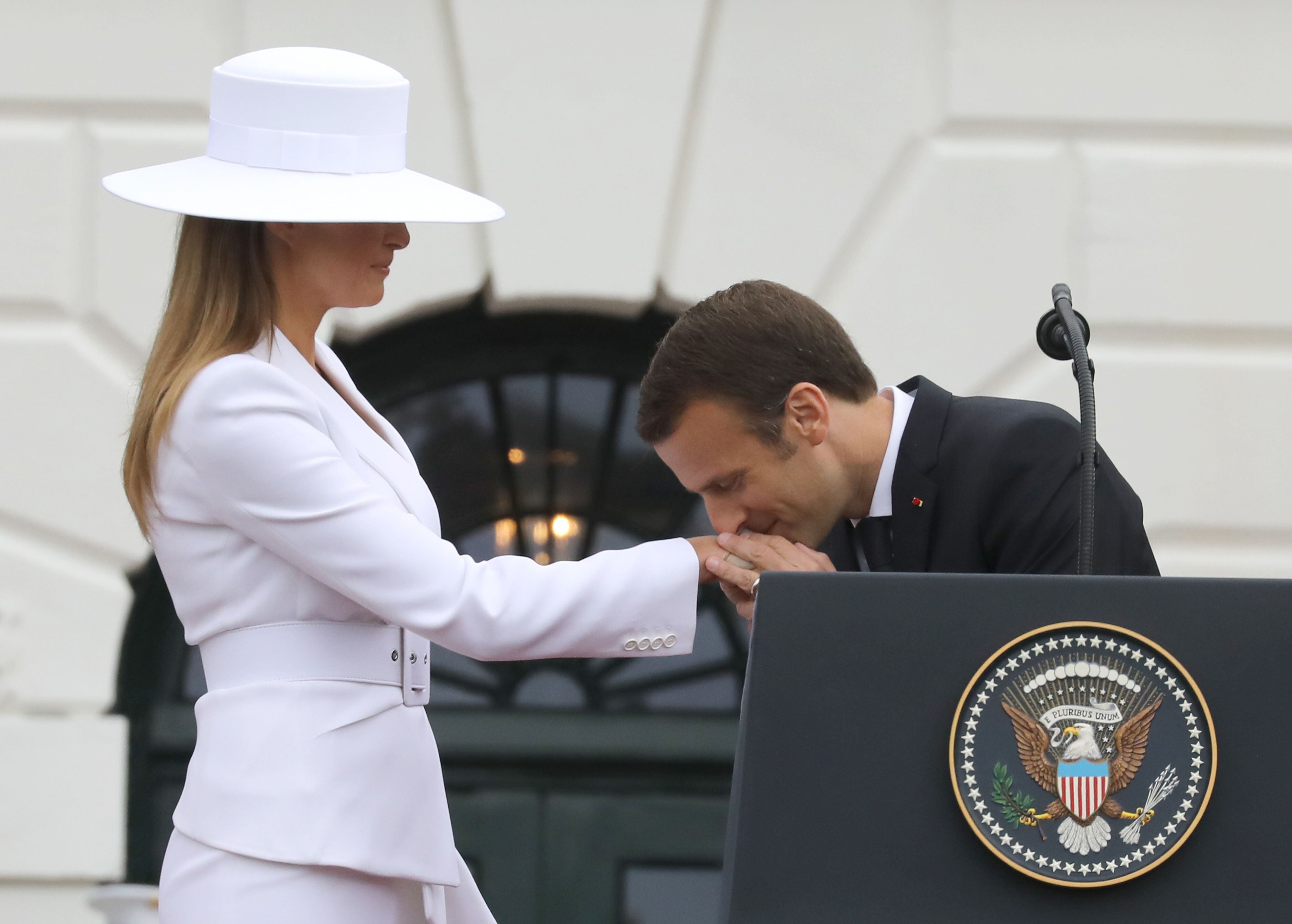 French President Emmanuel Macron kisses the hand of US First Lady Melania Trump during a state welcome at the White House in Washington, DC, on April 24, 2018. (Photo by Ludovic MARIN / AFP)        (Photo credit should read LUDOVIC MARIN/AFP via Getty Images)