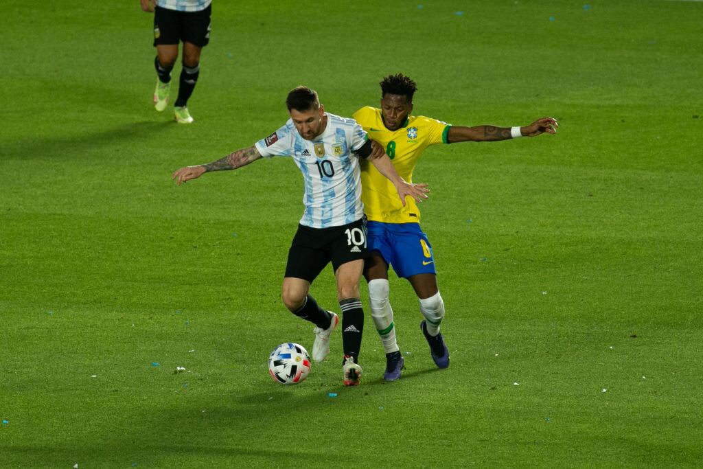SAN JUAN, ARGENTINA - NOVEMBER 16: Lionel Messi of Argentina fights for the ball with Fred of Brazil during a match between Argentina and Brazil as part of South American Qualifiers for Qatar 2022 World Cup at San Juan del Bicentenario Stadium on November 16, 2021 in San Juan, Argentina. (Photo by Florencia Tan Jun/PxImages/Icon Sportswire via Getty Images)