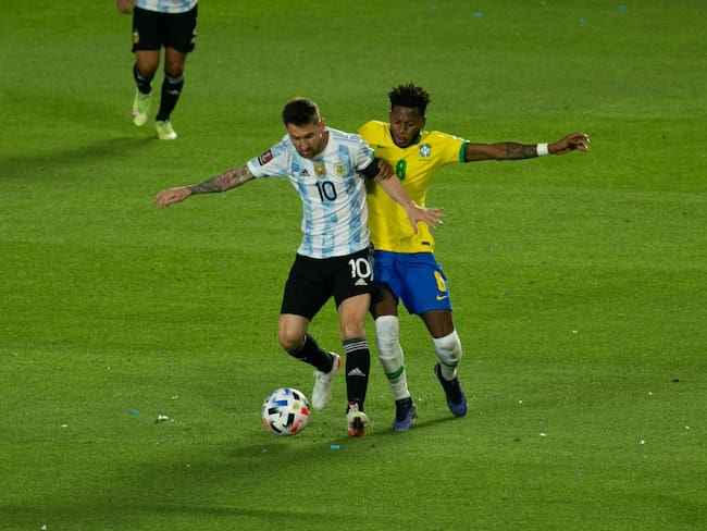 SAN JUAN, ARGENTINA - NOVEMBER 16: Lionel Messi of Argentina fights for the ball with Fred of Brazil during a match between Argentina and Brazil as part of South American Qualifiers for Qatar 2022 World Cup at San Juan del Bicentenario Stadium on November 16, 2021 in San Juan, Argentina. (Photo by Florencia Tan Jun/PxImages/Icon Sportswire via Getty Images)
