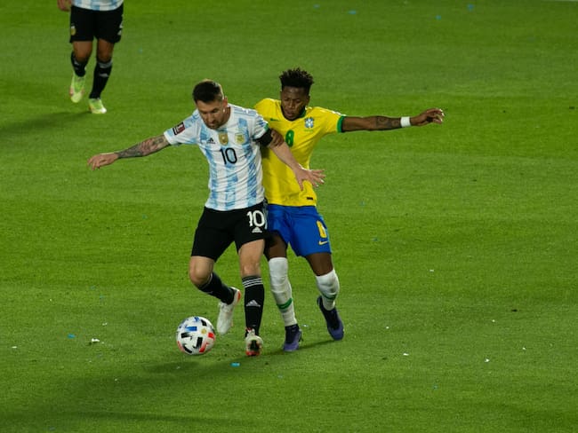 SAN JUAN, ARGENTINA - NOVEMBER 16: Lionel Messi of Argentina fights for the ball with Fred of Brazil during a match between Argentina and Brazil as part of South American Qualifiers for Qatar 2022 World Cup at San Juan del Bicentenario Stadium on November 16, 2021 in San Juan, Argentina. (Photo by Florencia Tan Jun/PxImages/Icon Sportswire via Getty Images)