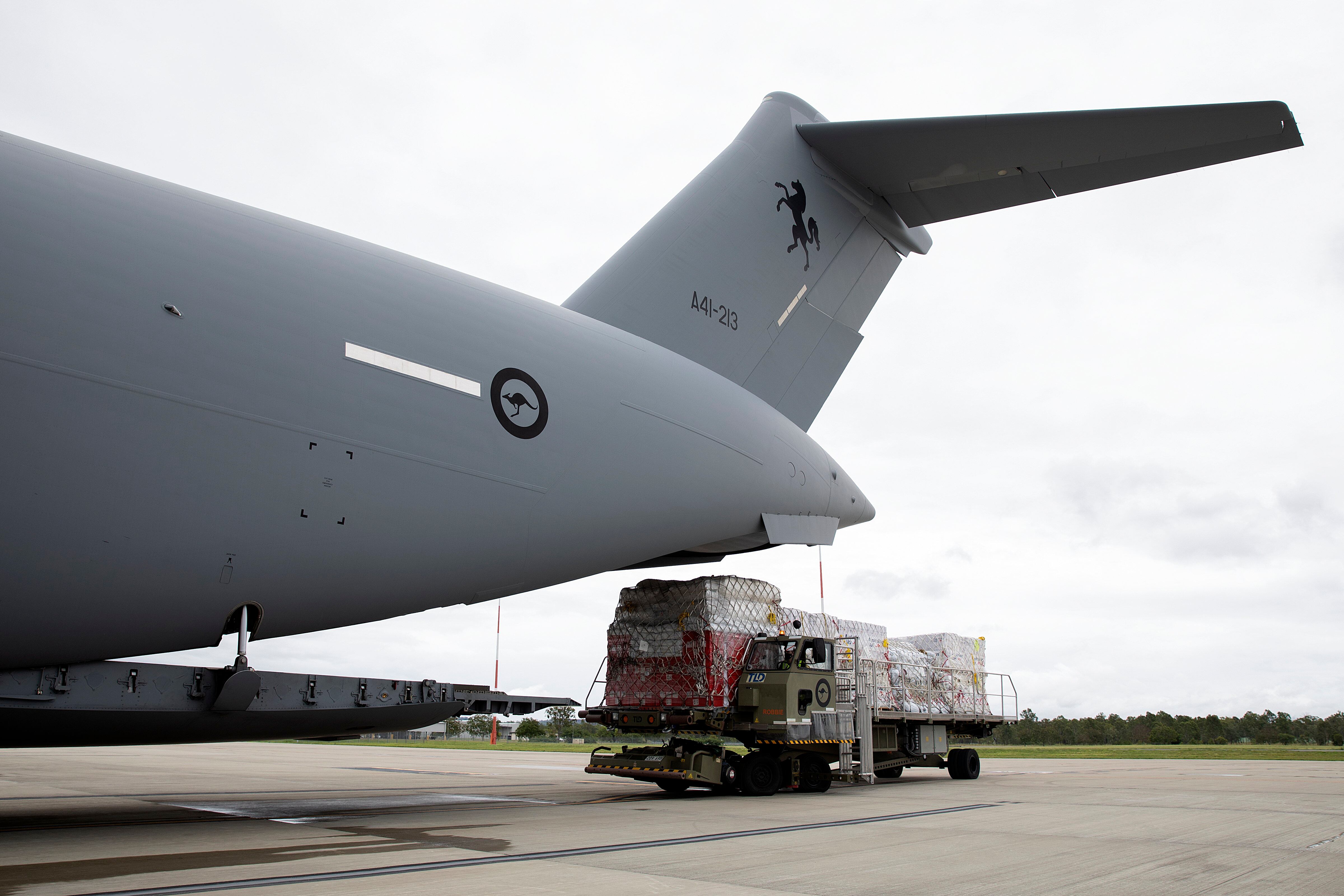 NUKU'ALOFA, TONGA - JANUARY 20: In this handout image provided by the Australian Defence Force, Australian Defence Force members load humanitarian aid supplies onto a Royal Australian Air Force C-17A Globemaster III aircraft at RAAF Base Amberley on January 20, 2022 in Nuku'alofa, Tonga. (Photo by LACW Kate Czerny/Australian Defence Force via Getty Images)
