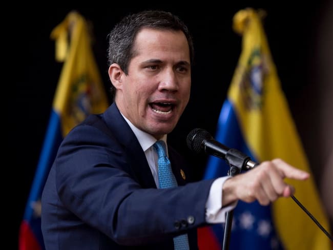TOPSHOT - Venezuelan opposition leader Juan Guaido delivers a speech during the installation of the National Parliament for the legislative period 2022-2023, which he presides, in Caracas, on January 5, 2022. - Opposition leader Juan Guaido was ratified on Monday January 3 by the fractured opposition as &quot;in charge of the presidency&quot; of Venezuela, a figure that the leader adopted in 2019 with international support to try to displace from power, unsuccessfully, the socialist President Nicolas Maduro. (Photo by Pedro Rances Mattey / AFP) (Photo by PEDRO RANCES MATTEY/AFP via Getty Images)