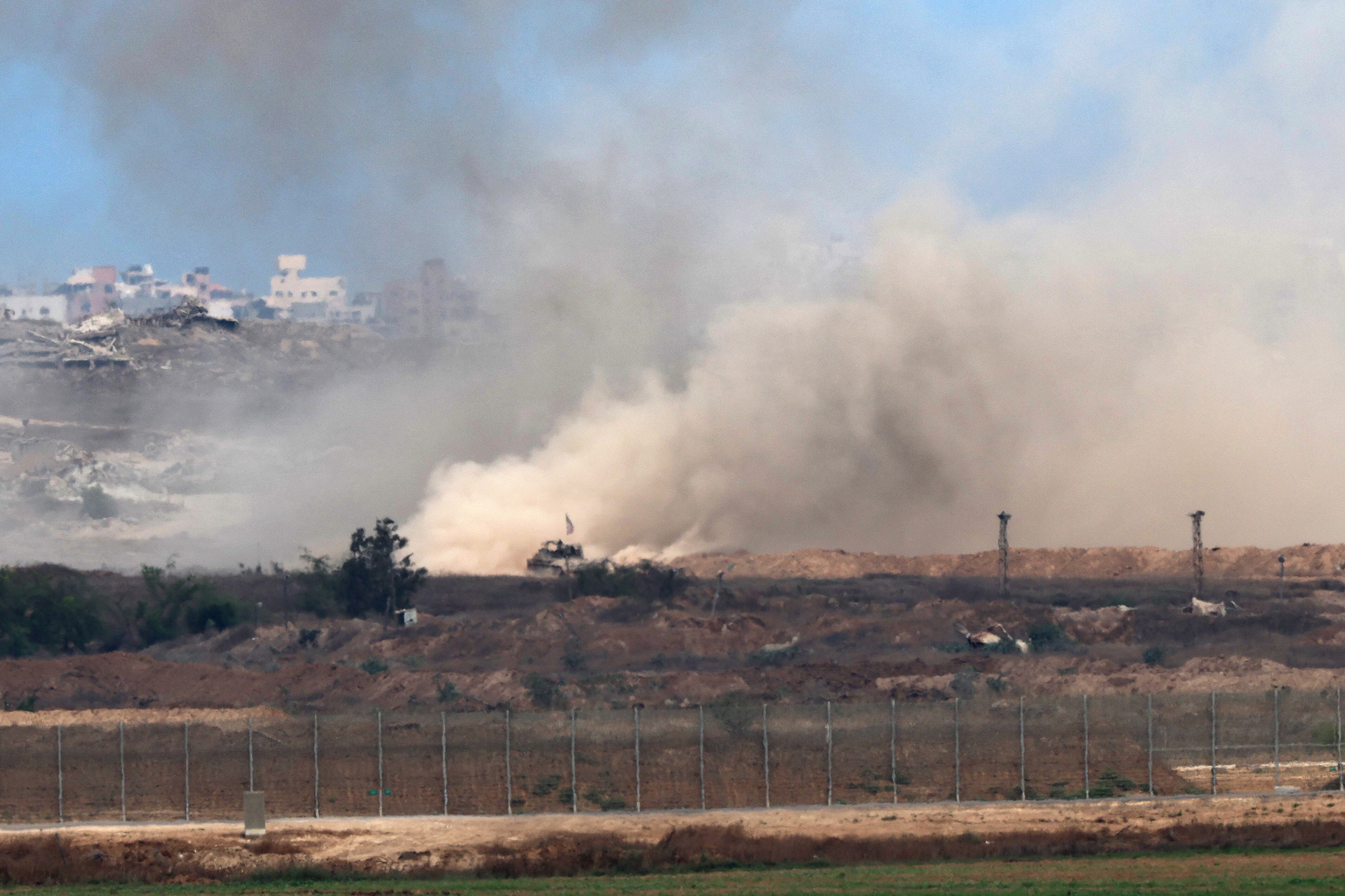 A picture taken from a position at the Israeli border with the Gaza Strip, shows an Israeli Tank moving in the besieged Palestinian territory on August 1, 2025. Israeli forces have killed hundreds of hungry Palestinians waiting for aid outside US-backed food distribution points, the UN's rights office said, as US special envoy Steve Witkoff was due to inspect the sites. (Photo by Jack GUEZ / AFP)