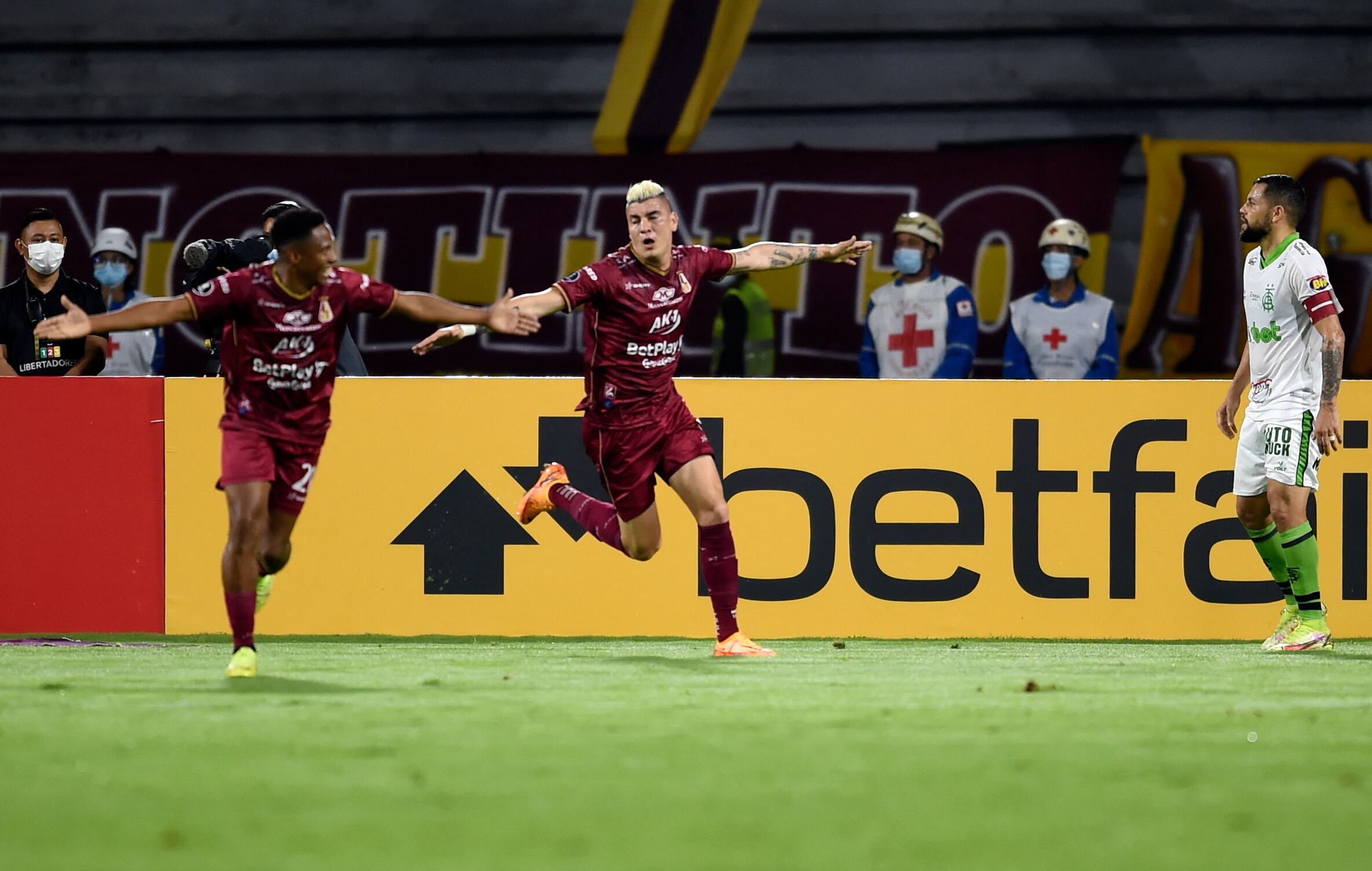 Colombia's Deportes Tolima Michael Rangel (C) celebrates after scoring against Brazil's America MG during their Copa Libertadores group stage football match, at the Manuel Murillo Toro stadium, in Tolima, Colombia, on May 18, 2022. (Photo by Daniel Munoz / AFP) (Photo by DANIEL MUNOZ/AFP via Getty Images)
