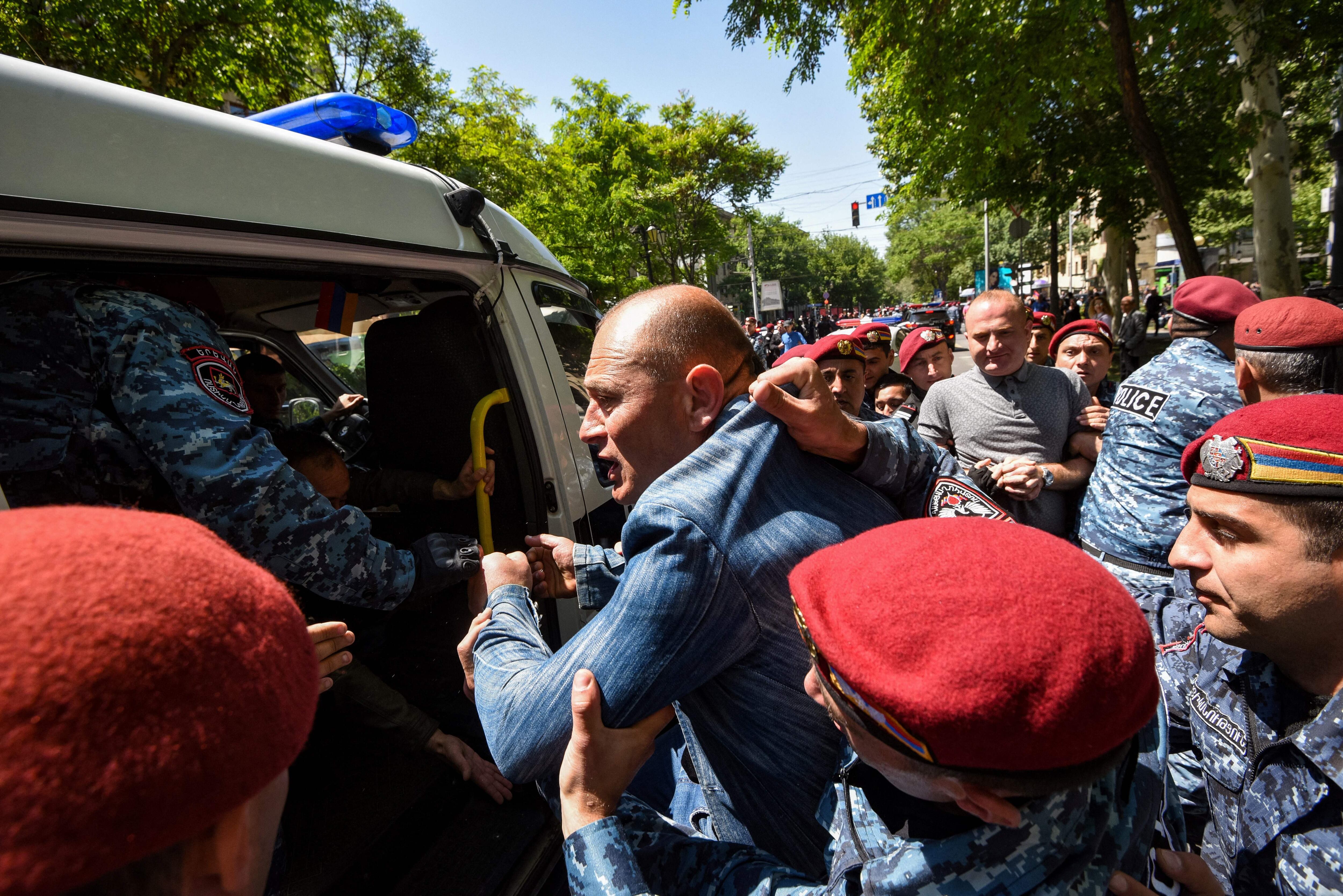 Police officers detain opposition supporters who attempted to block streets in the capital Yerevan on May 17, 2022. - Since mid-April, opposition parties have been staging rallies demanding Prime Minister Nikol Pashinyan's resignation over his handling of a territorial dispute with Azerbaijan. Arch-foes Armenia and Azerbaijan fought two wars -- in 2020 and in the 1990s -- over the long-contested region of Nagorno-Karabakh. Six-weeks of fighting in autumn 2020 claimed more than 6,500 lives and ended with a Russian-brokered ceasefire agreement. Under the deal, Armenia ceded swathes of territory it had controlled for decades, and Russia deployed some 2,000 peacekeepers to oversee the truce. (Photo by Karen MINASYAN / AFP) (Photo by KAREN MINASYAN/AFP via Getty Images)
