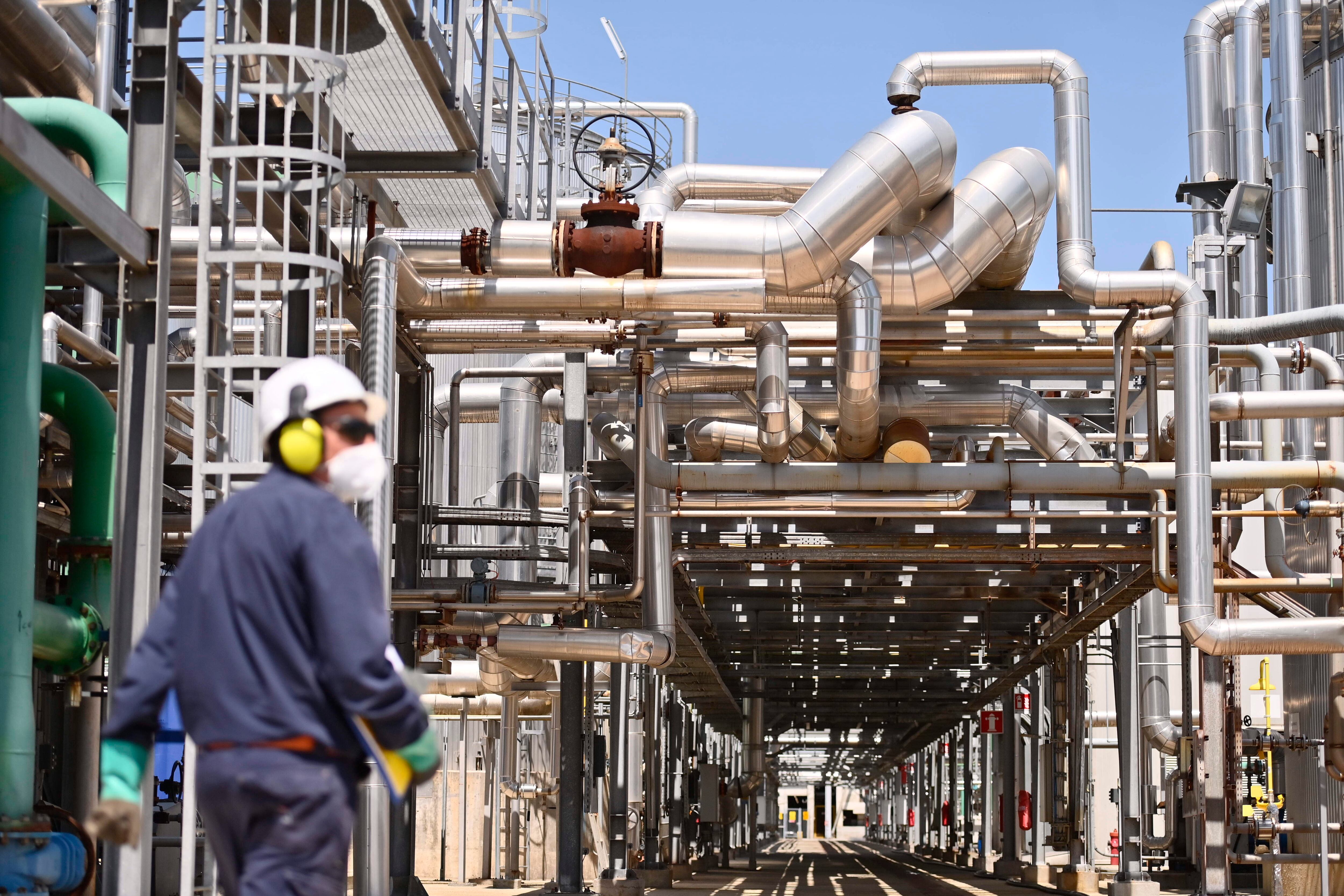 CRESCENTINO, ITALY - MAY 26: Worker walks inside of the Biogas Eni Versalis Chemical Factory on May 26, 2022 in Crescentino, Italy. The ENI Versalis Factory in Crescentino near Vercelli specializes in the production of bioethanol from lignocellulosic biomass and allows the production of biogas. The site is self-sustaining from an energy point of view, thanks to the production of renewable electricity and steam from the thermoelectric plant which is powered by short-chain biomass and by the lignin co-produced by the process. (Photo by Stefano Guidi/Getty Images)