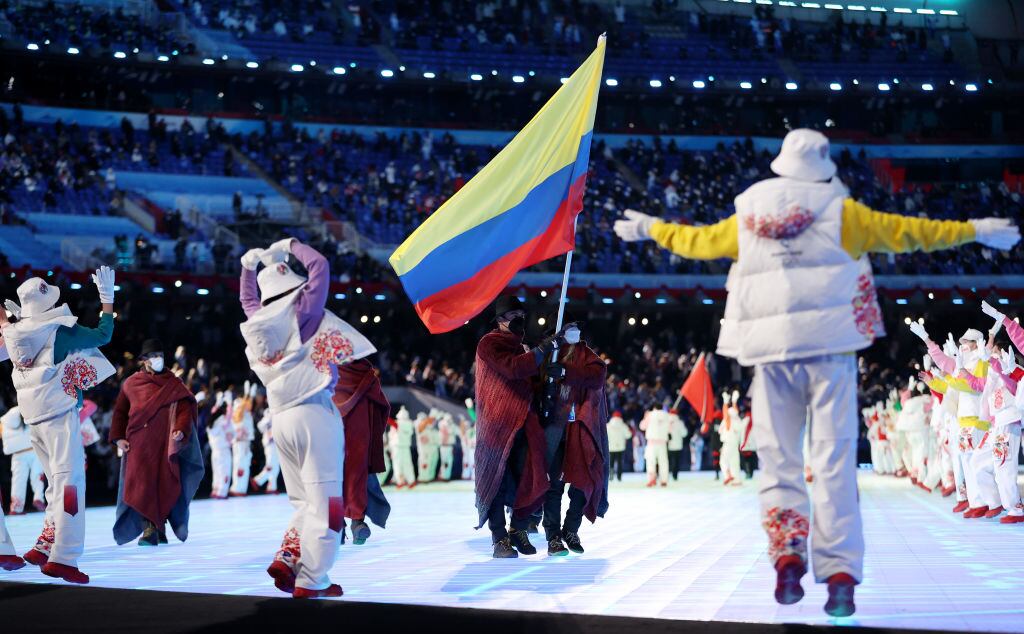 BEIJING, CHINA - FEBRUARY 04: Flag bearers Laura Gomez and Carlos Andres Quintana of Team Colombia carry their flag during the Opening Ceremony of the Beijing 2022 Winter Olympics at the Beijing National Stadium on February 04, 2022 in Beijing, China. (Photo by Catherine Ivill/Getty Images)