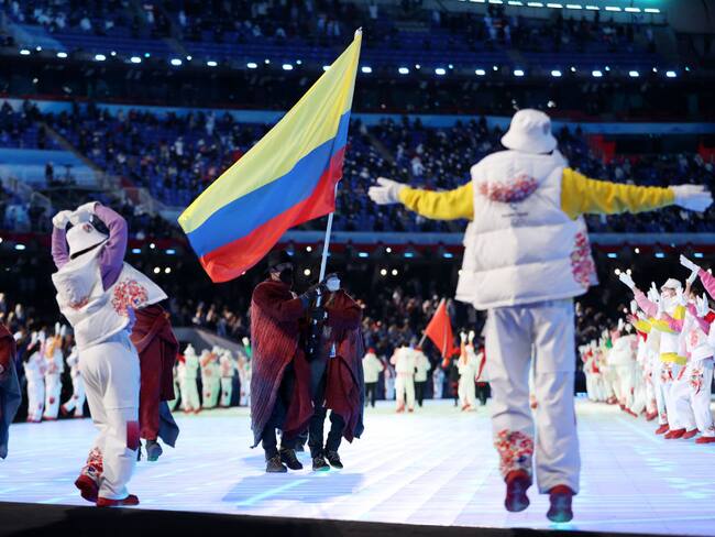 BEIJING, CHINA - FEBRUARY 04: Flag bearers Laura Gomez and Carlos Andres Quintana of Team Colombia carry their flag during the Opening Ceremony of the Beijing 2022 Winter Olympics at the Beijing National Stadium on February 04, 2022 in Beijing, China. (Photo by Catherine Ivill/Getty Images)