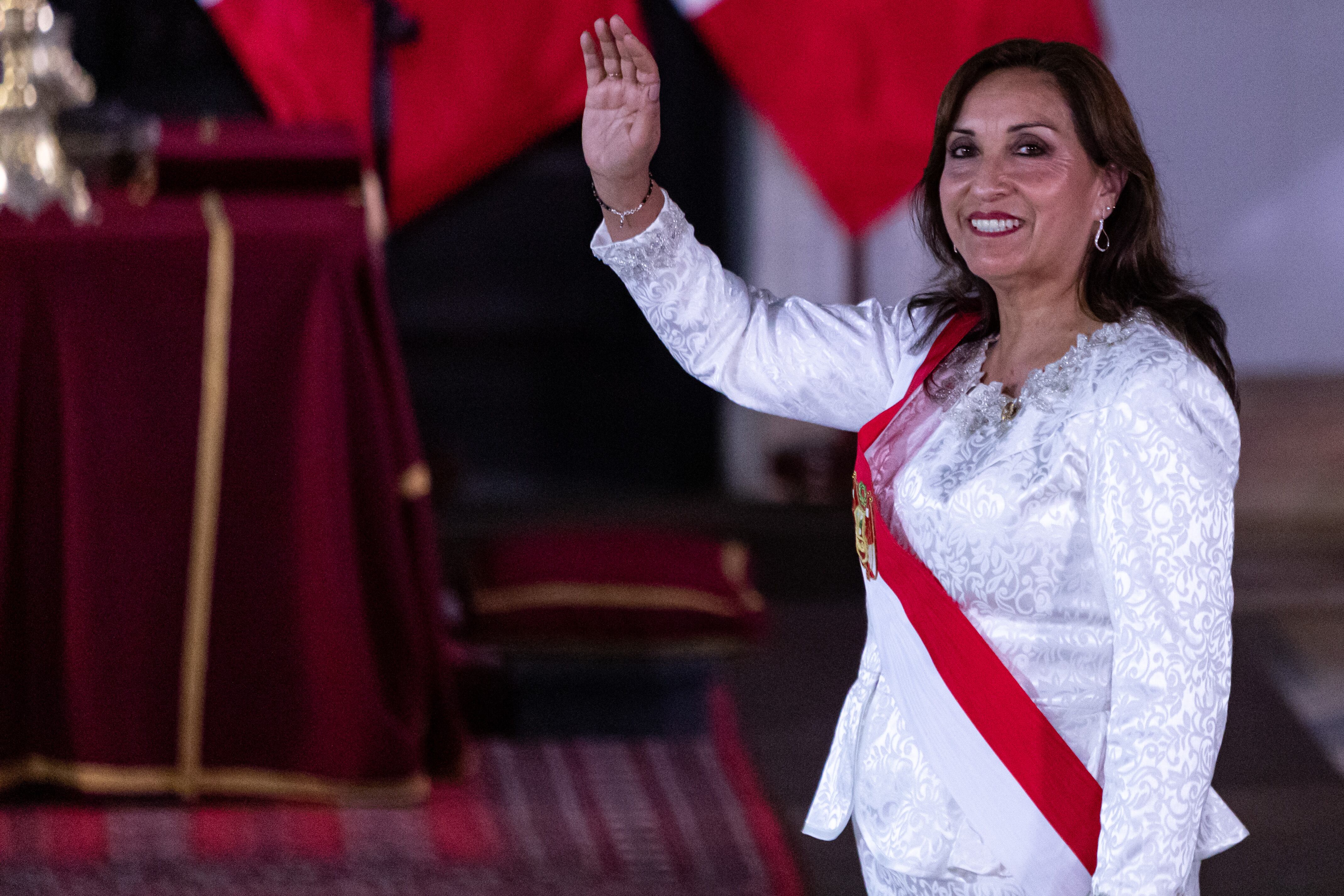 10 December 2022, Peru, Lima: Dina Boluarte, interim president of Peru, waves during the swearing-in ceremony of cabinet members at the Government Palace. Photo: Lucas Aguayo Araos/dpa (Photo by Lucas Aguayo Araos/picture alliance via Getty Images)