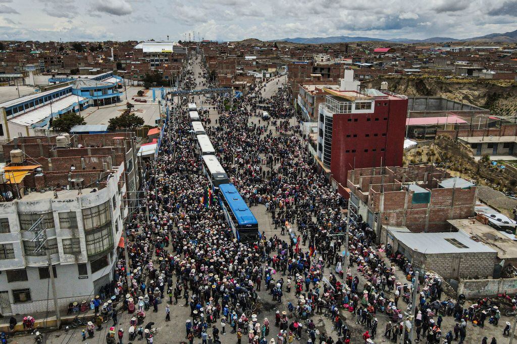 TOPSHOT - People say goodbye to demonstrators as they depart to Lima to protest against the government of Peruvian President Dina Boluarte in the city of Ilave, Puno, southern Peru on January 17, 2023. - Peruvian President Dina Boluarte asked this Tuesday to the hundreds of protesters from various regions of the country who are heading to Lima to protest against their government to do so in "peace and calm." (Photo by Juan Carlos CISNEROS / AFP) (Photo by JUAN CARLOS CISNEROS/AFP via Getty Images)