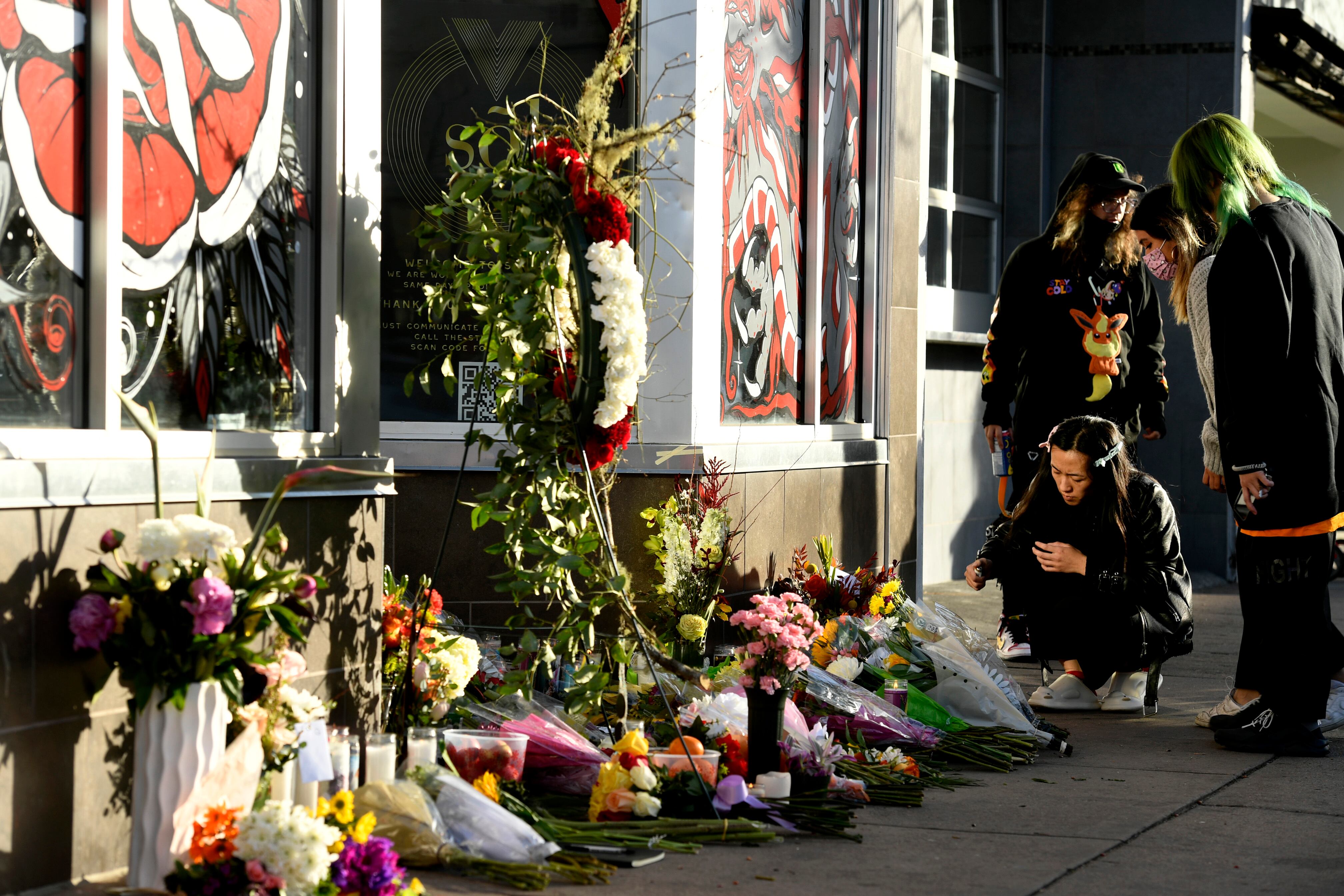 DENVER, CO - DECEMBER 28: Mourners light candles and place flowers in front of a makeshift memorial outside Sol Tribe Custom Tattoo and Body Piercing shop on Broadway where, on Monday, two women were killed and a man were injured in a shooting rampage on December 28, 2021 in Denver, Colorado. (Photo by Helen H. Richardson/MediaNews Group/The Denver Post via Getty Images)