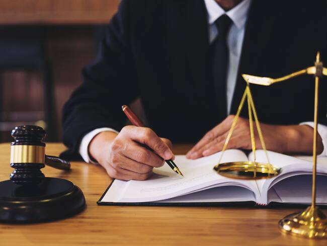 Judge gavel with Justice lawyers, Businessman in suit or lawyer working on a documents. Legal law, advice and justice concept.