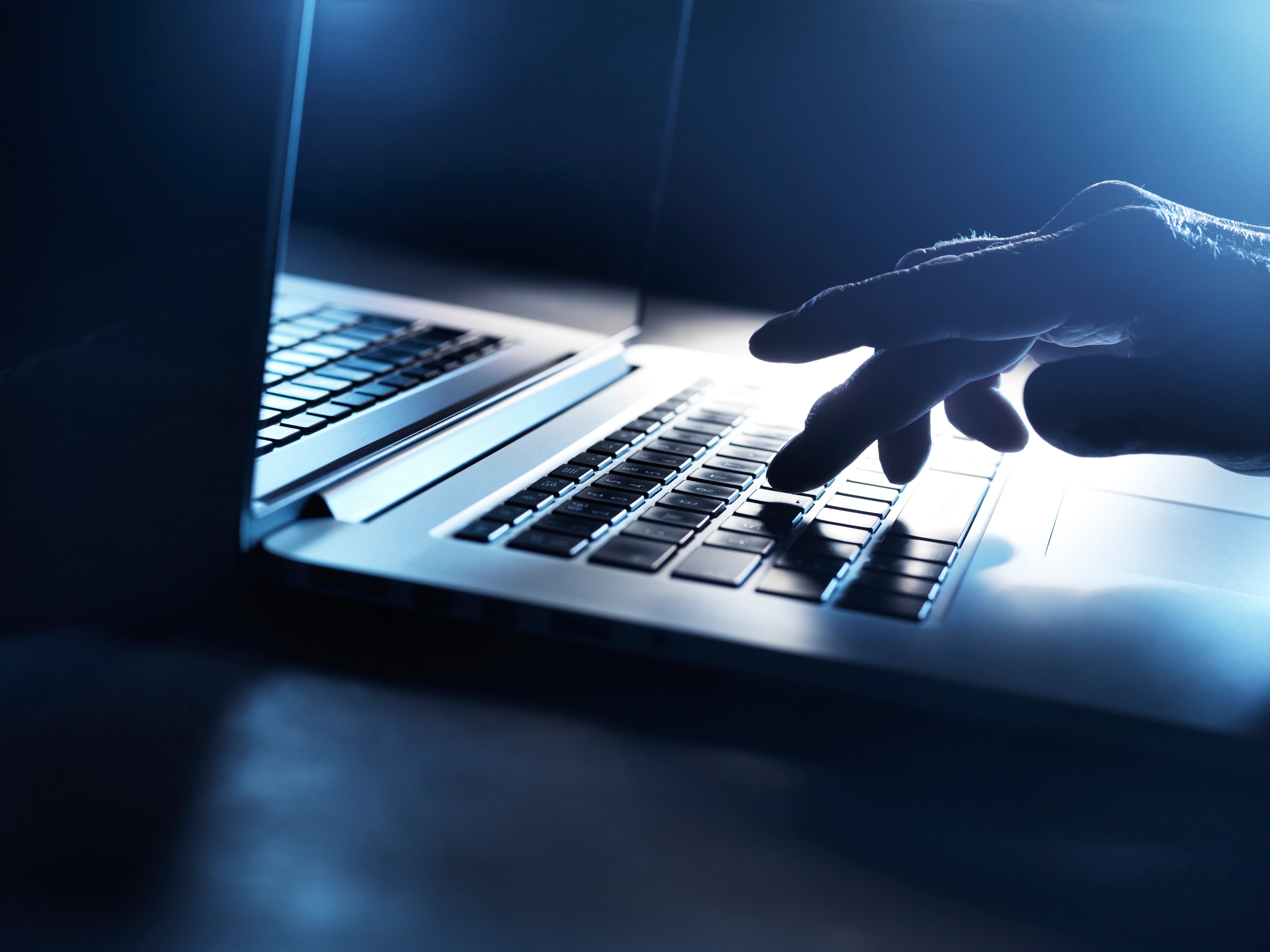 Typing on a laptop computer.