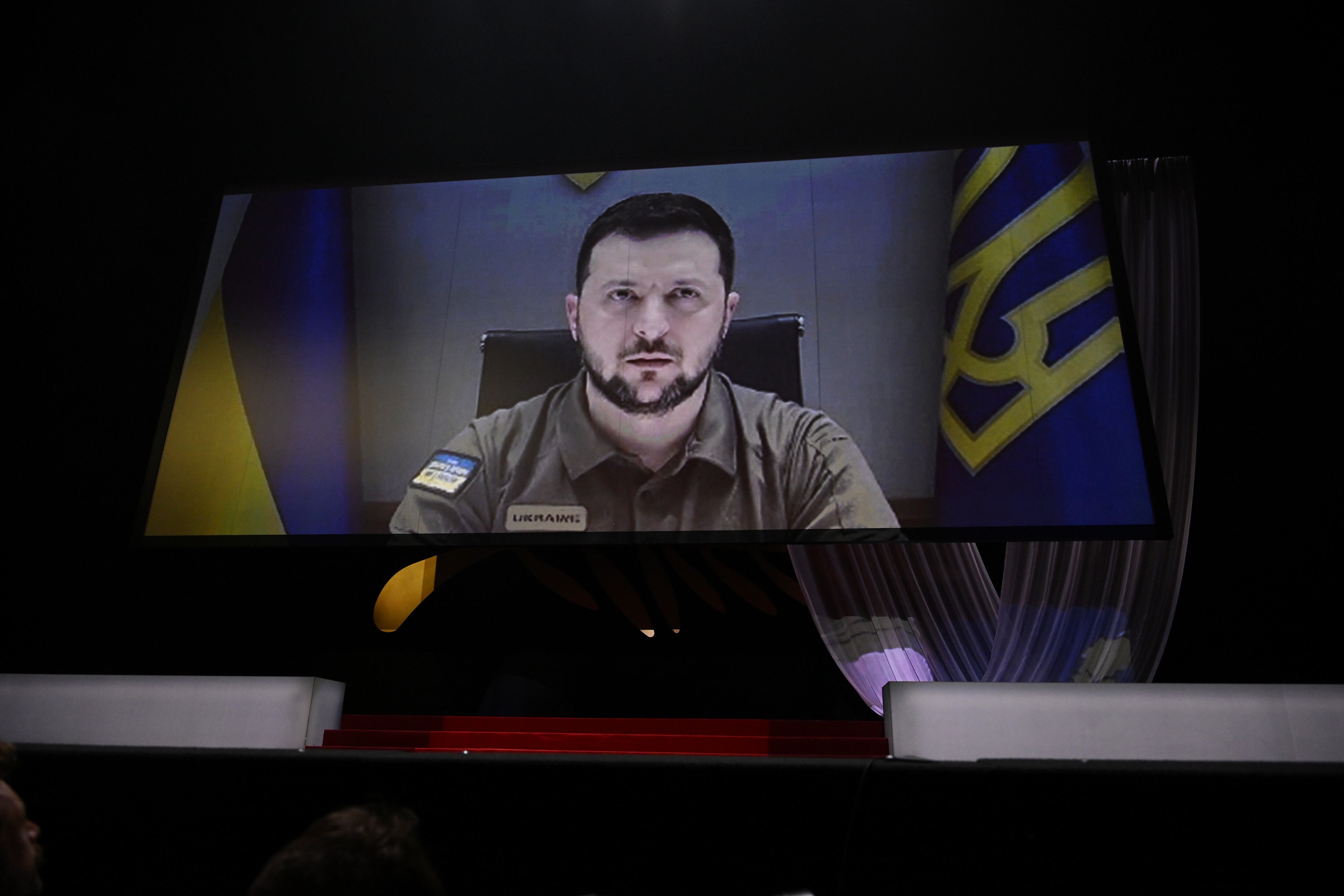 CANNES, FRANCE - MAY 17: President of Ukraine Volodymyr Zelenskyy speaks in a live link-up video during the opening ceremony for the 75th annual Cannes film festival at Palais des Festivals on May 17, 2022 in Cannes, France. (Photo by Stephane Cardinale - Corbis/Corbis via Getty Images)
