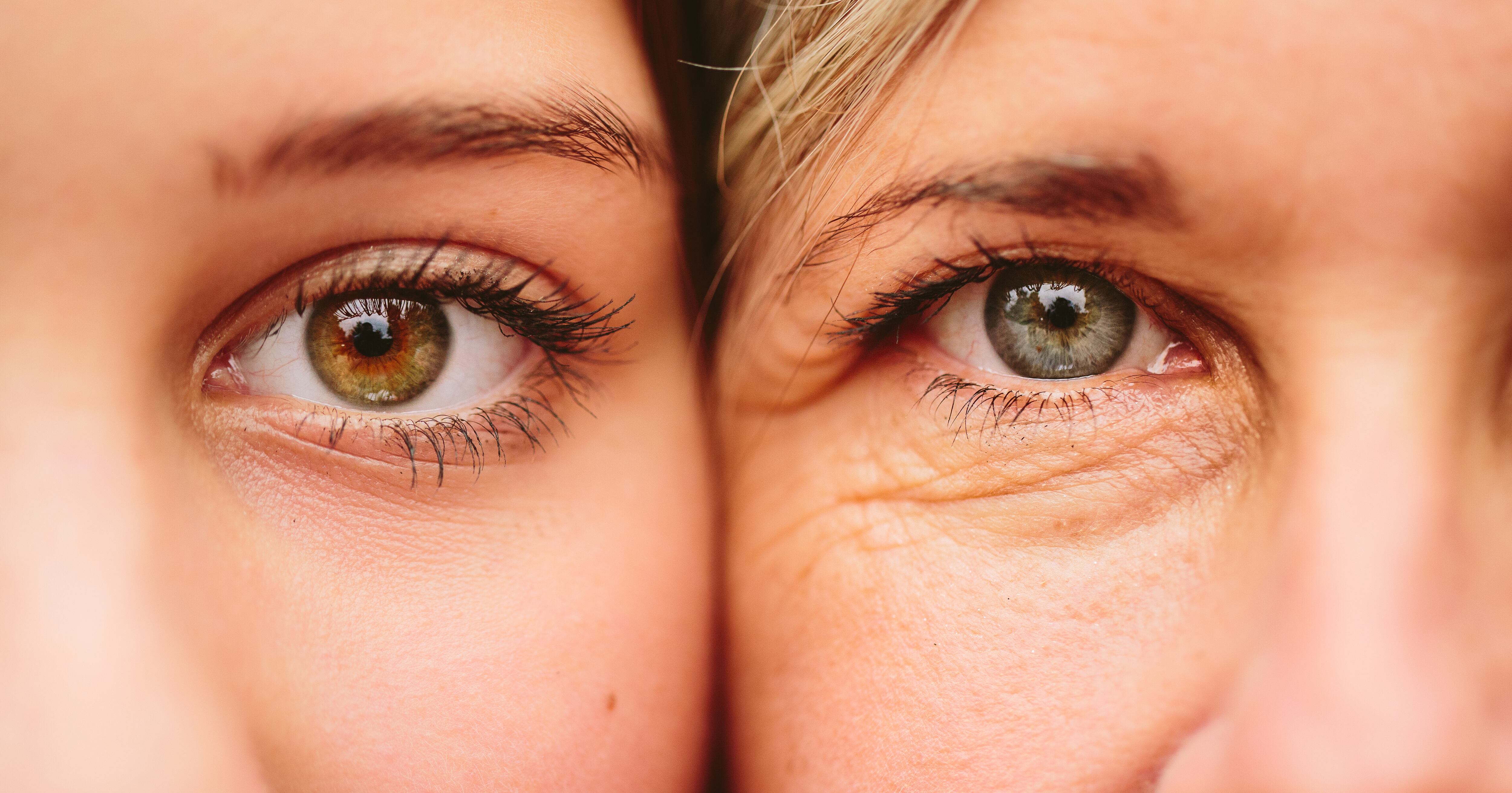 Close up on eyes of mother and daughter faces next to one another