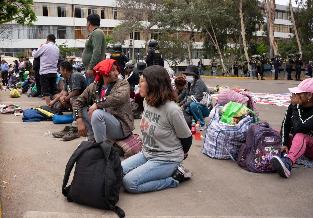 Alleged protesters wait to be transferred after being arrested by police on the University of San Marcos campus in Lima on January 21, 2023. - Civil unrest since the ouster of Dina Boluarte's predecessor, Pedro Castillo, in early December has left 45 people dead and prompted the government to impose a state of emergency in violence-hit areas. (Photo by Juan MANDAMIENTO / AFP) (Photo by JUAN MANDAMIENTO/AFP via Getty Images)