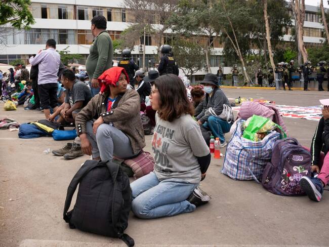 Alleged protesters wait to be transferred after being arrested by police on the University of San Marcos campus in Lima on January 21, 2023. - Civil unrest since the ouster of Dina Boluarte's predecessor, Pedro Castillo, in early December has left 45 people dead and prompted the government to impose a state of emergency in violence-hit areas. (Photo by Juan MANDAMIENTO / AFP) (Photo by JUAN MANDAMIENTO/AFP via Getty Images)