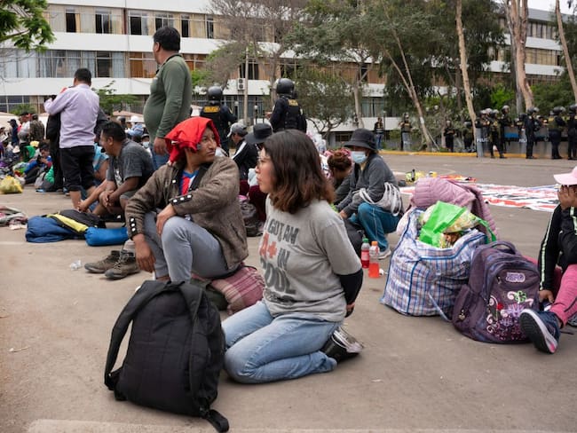 Alleged protesters wait to be transferred after being arrested by police on the University of San Marcos campus in Lima on January 21, 2023. - Civil unrest since the ouster of Dina Boluarte&#039;s predecessor, Pedro Castillo, in early December has left 45 people dead and prompted the government to impose a state of emergency in violence-hit areas. (Photo by Juan MANDAMIENTO / AFP) (Photo by JUAN MANDAMIENTO/AFP via Getty Images)