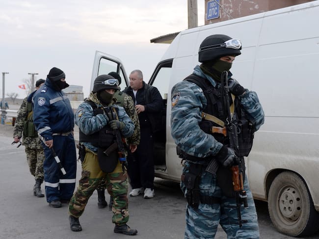 Pro-Russian forces check a van driver&#039;s documents and vehicle at a checkpoint in Chongar, in the border area between Crimea and the Kherson region of Ukraine. (Photo credit should read VASILY MAXIMOV/AFP via Getty Images)