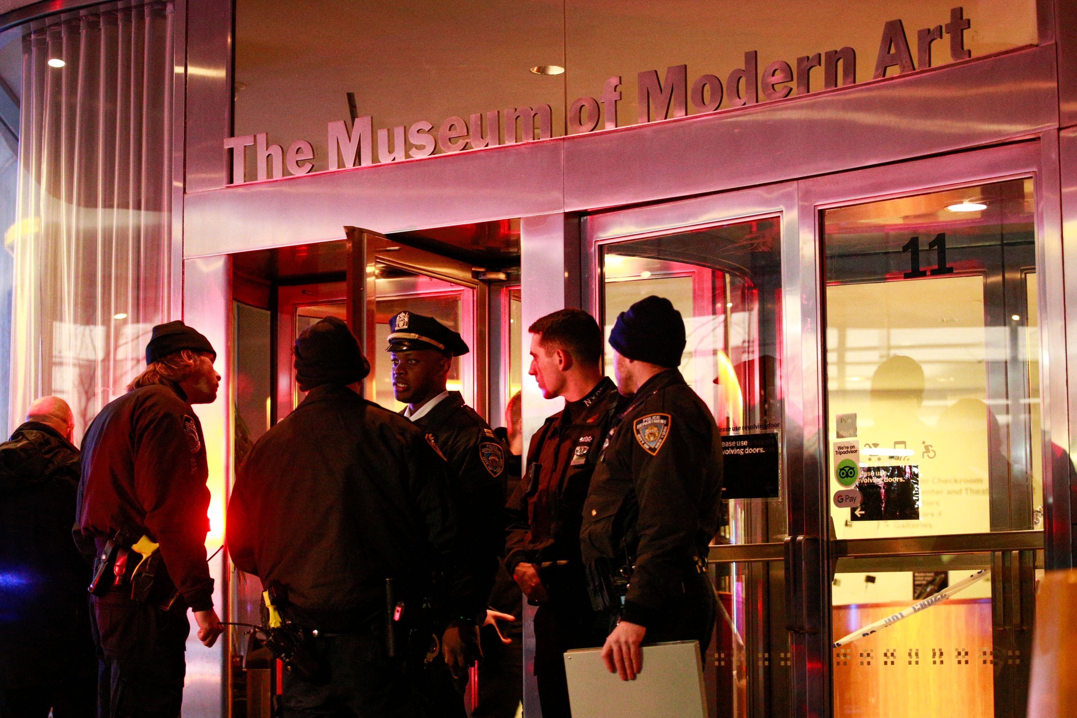 New York City police officers stand guard at the entrance of the Museum of Modern Art in New York City on March 12, 2022. - Two people were stabbed at New York's prestigious Museum of Modern Art on Saturday, police said, causing the museum to be evacuated. (Photo by Kena Betancur / AFP) (Photo by KENA BETANCUR/AFP via Getty Images)