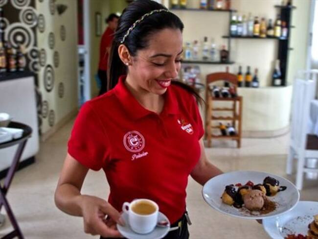 Una camarera soriente y vestida de rojo... propina a la vista. Foto: Getty Images
