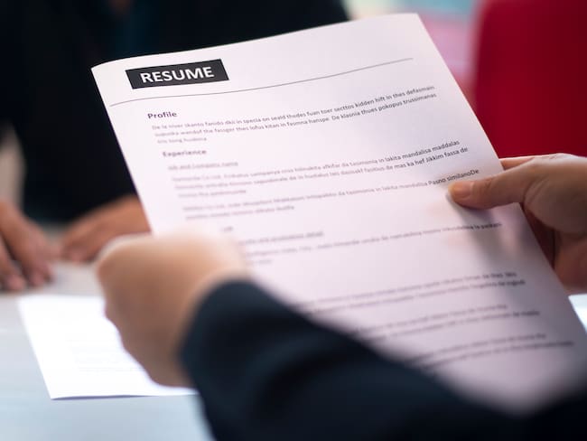 Recruitment, Job application, contract and business employment concept. Hand giving the resume to the recruiter to review the profile of the applicant.