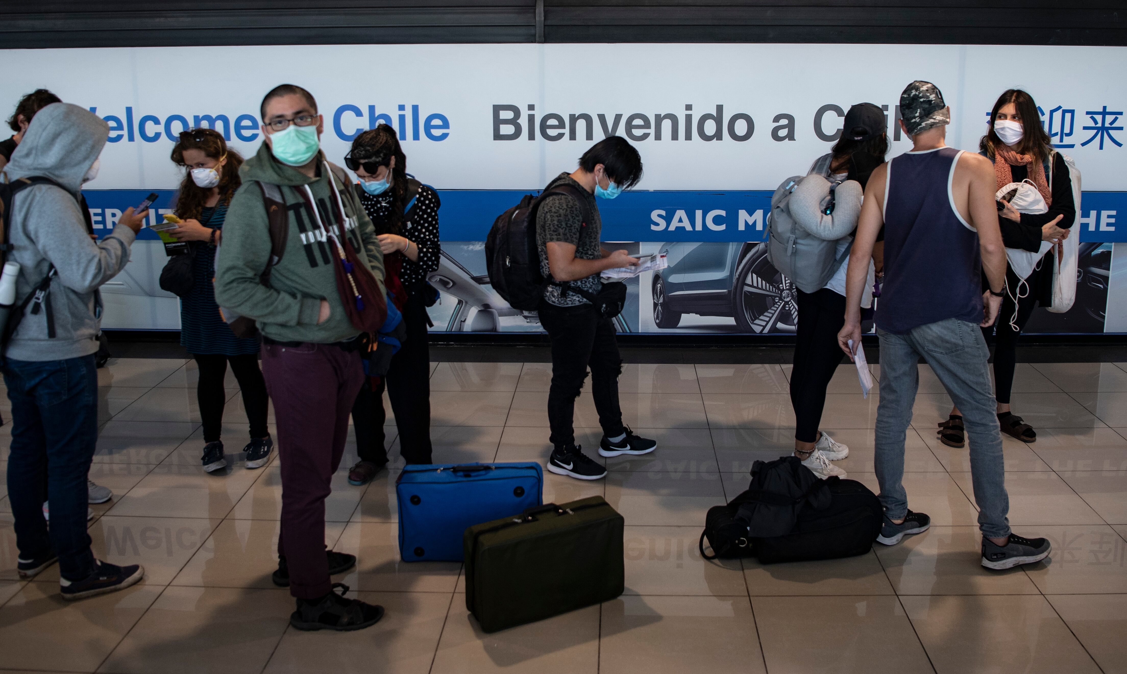 Repatriated Chilean passengers queue at the immigration counter upon their arrival at the International Airport in Santiago on May 08, 2020. (Photo by MARTIN BERNETTI / AFP) (Photo by MARTIN BERNETTI/AFP via Getty Images)
