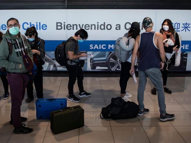 Repatriated Chilean passengers queue at the immigration counter upon their arrival at the International Airport in Santiago on May 08, 2020. (Photo by MARTIN BERNETTI / AFP) (Photo by MARTIN BERNETTI/AFP via Getty Images)