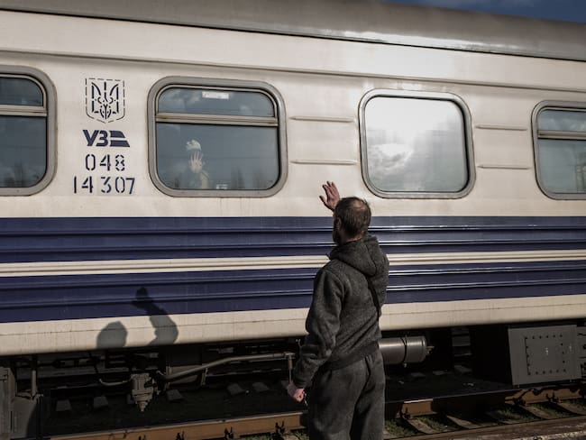 KRAMATORSK, UKRAINE - APRIL 6: A man waves at his relative after boarding a train as civilians are being evacuated from combat zones in Kramatorsk, Donetsk Oblast, in eastern Ukraine on April 6, 2022. Civilians search to board the first available train headed west. (Photo by Andrea Carrubba/Anadolu Agency via Getty Images)