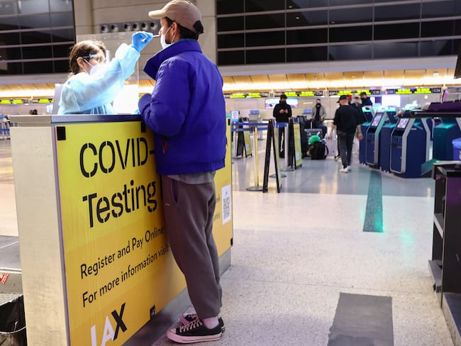 LOS ANGELES, CALIFORNIA - DECEMBER 01: A person is tested for COVID-19 inside the Tom Bradley International Terminal at Los Angeles International Airport (LAX) on December 01, 2021 in Los Angeles, California. (Photo by Mario Tama/Getty Images)