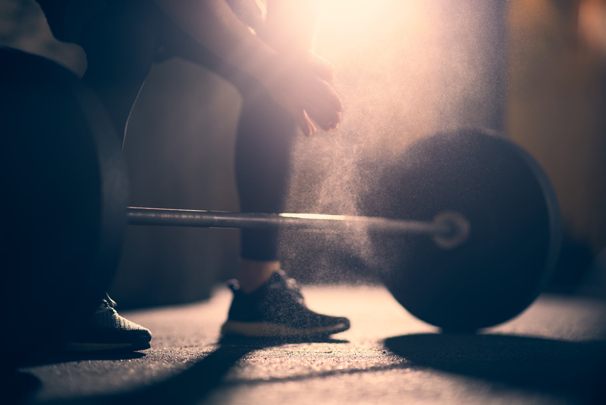 Man preparing to lift dumbell in a gym