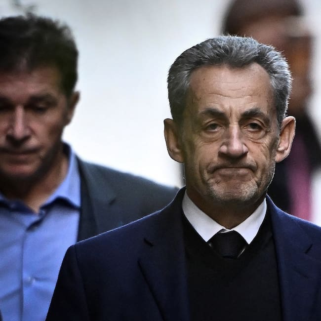 (FILES) France's former president Nicolas Sarkozy leaves his residence to present himself to La Sante Prison for incarceration on a five-year prison sentence after being convicted of criminal conspiracy over a plan for late Libyan dictator Moamer Kadhafi to fund his 2007 electoral campaign, in Paris, on October 21, 2025. Less than two weeks after his release from prison, Nicolas Sarkozy announced on November 21, the release on December 10 of his new book entitled "Journal d'un Prisonnier" (Journal of a prisoner) on his incarceration at Paris' Prison de la Sante. Nicolas Sarkozy was released under judicial supervision on November 10, pending an appeals trial over allegations that he sought Libyan funding. (Photo by JULIEN DE ROSA / AFP)