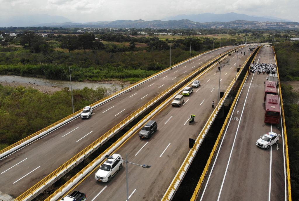 Aerial view taken from Urena, in Venezuela, with Cucuta, Colombia, in the background, showing authorities and other people gathering at the Atanasio Girardot International Bridge -formerly known as Tienditas bridge- during the official reopening of their shared land border, on January 1, 2023. - Venezuela and Colombia reopened the last stretch of their shared border that had remained closed for years in a diplomatic dispute now settled under new leadership in Colombia, with its first-ever left-wing president, Gustavo Petro. Their borders were partially closed seven years ago and completely blocked in 2019 when Venezuela's leader Nicolas Maduro broke off diplomatic ties after Colombia under then president Ivan Duque questioned his 2018 re-election. (Photo by Edinson ESTUPINAN / AFP) (Photo by EDINSON ESTUPINAN/AFP via Getty Images)