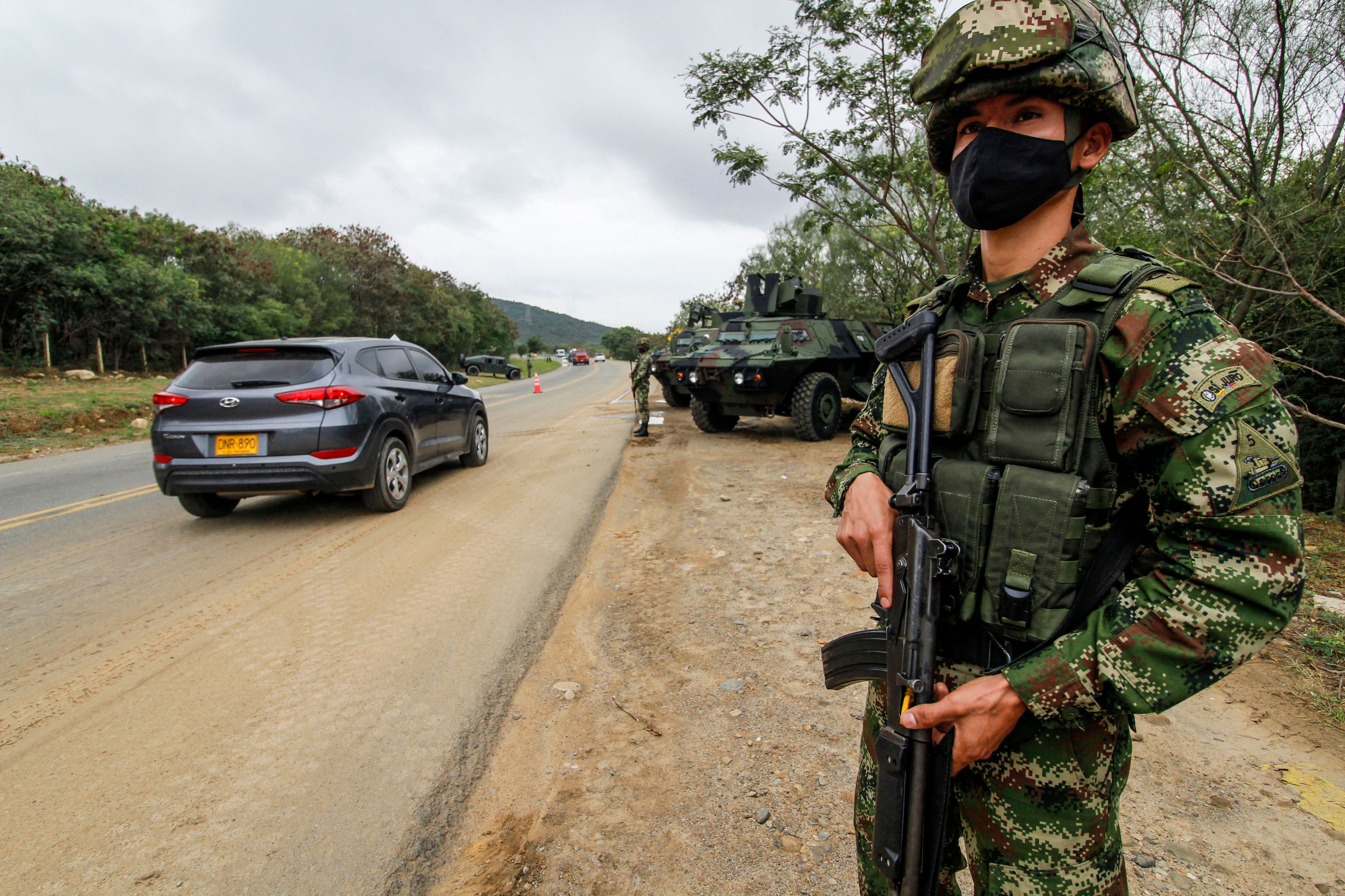 Soldiers stand guard at a check point in an avenue in Cucuta, near Venezuelan border, in Colombia on February 7, 2022. (Photo by Schneyder MENDOZA / AFP) (Photo by SCHNEYDER MENDOZA/AFP via Getty Images)