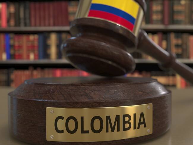 Flag on falling judge's gavel in court. National justice related conceptual 3D