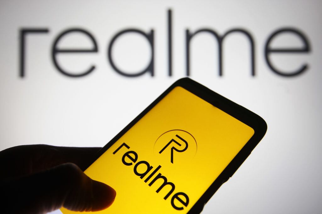 Realme (Realme Chongqing Mobile Telecommunications Corporation Ltd.) logo is seen on a smartphone and a computer screen. (Photo Illustration by Pavlo Gonchar/SOPA Images/LightRocket via Getty Images)