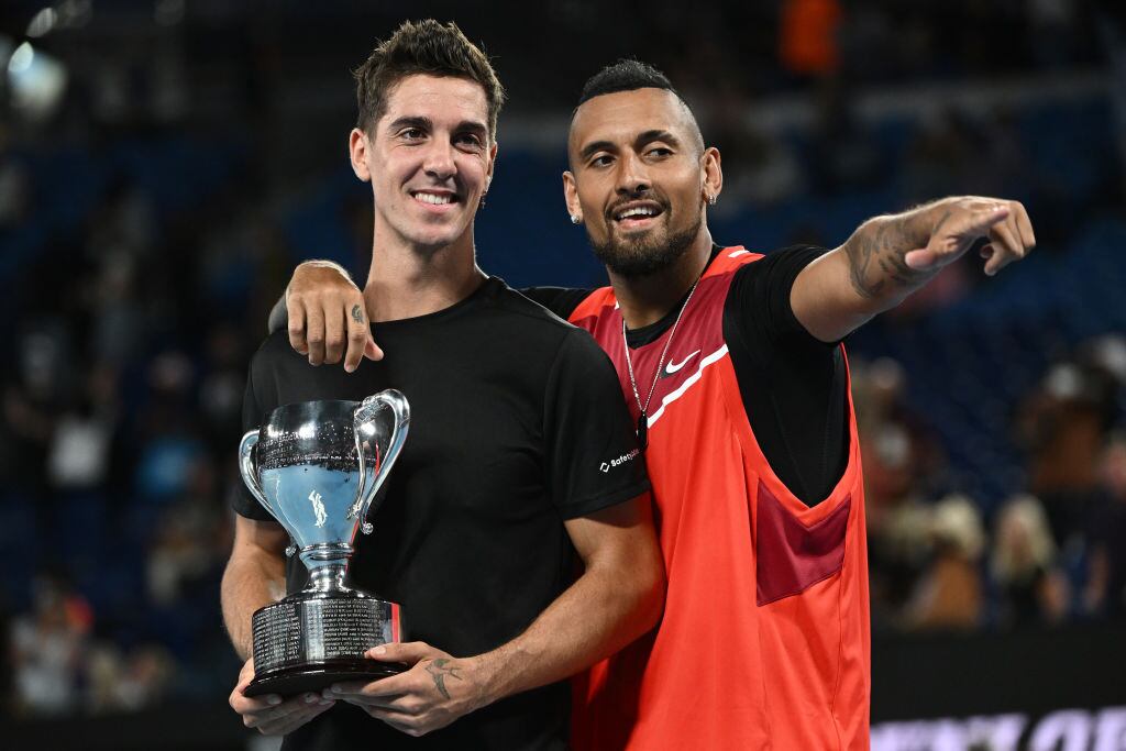 MELBOURNE, AUSTRALIA - JANUARY 29: Thanasi Kokkinakis (L) of Australia and Nick Kyrgios of Australia pose with the championship trophy after winning their Men's Doubles Final match against Matthew Ebden of Australia and Max Purcell of Australia during day 13 of the 2022 Australian Open at Melbourne Park on January 29, 2022 in Melbourne, Australia. (Photo by Quinn Rooney/Getty Images)