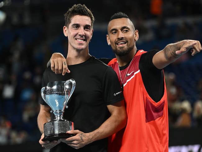 MELBOURNE, AUSTRALIA - JANUARY 29: Thanasi Kokkinakis (L) of Australia and Nick Kyrgios of Australia pose with the championship trophy after winning their Men&#039;s Doubles Final match against Matthew Ebden of Australia and Max Purcell of Australia during day 13 of the 2022 Australian Open at Melbourne Park on January 29, 2022 in Melbourne, Australia. (Photo by Quinn Rooney/Getty Images)