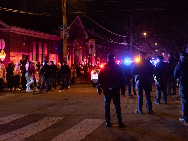 PHILADELPHIA, PA - JANUARY 05: Police and local residents are pictured near the scene of the fatal fire in the Fairmount neighborhood on January 5, 2022 in Philadelphia, Pennsylvania. A fire killed 13 people, including seven children, in a Philadelphia rowhouse on Wednesday morning, officials said. (Photo by Hannah Beier/Getty Images)