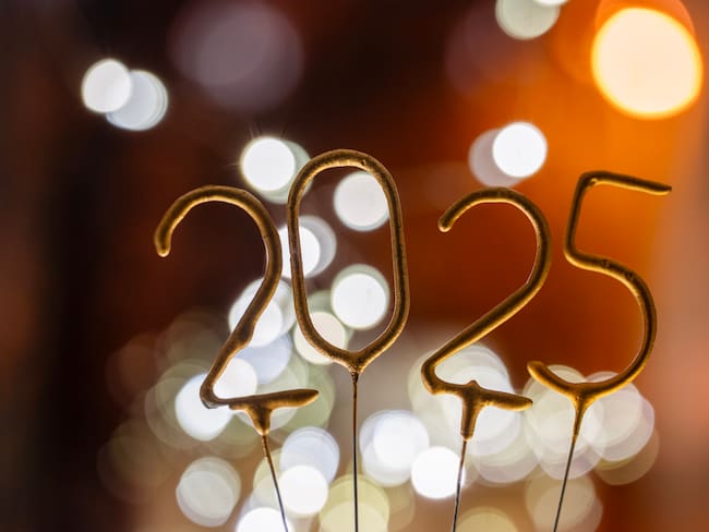 Golden Sparkler as 2025 shine brightly, illuminating a festive atmosphere filled with cheerful bokeh lights in the background