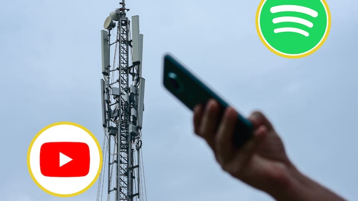 Persona usando los datos del celular al lado de una antena de telecomunicaciones. En los círculos, los logos de Spotify y YouTube (Fotos vía GettyImages)