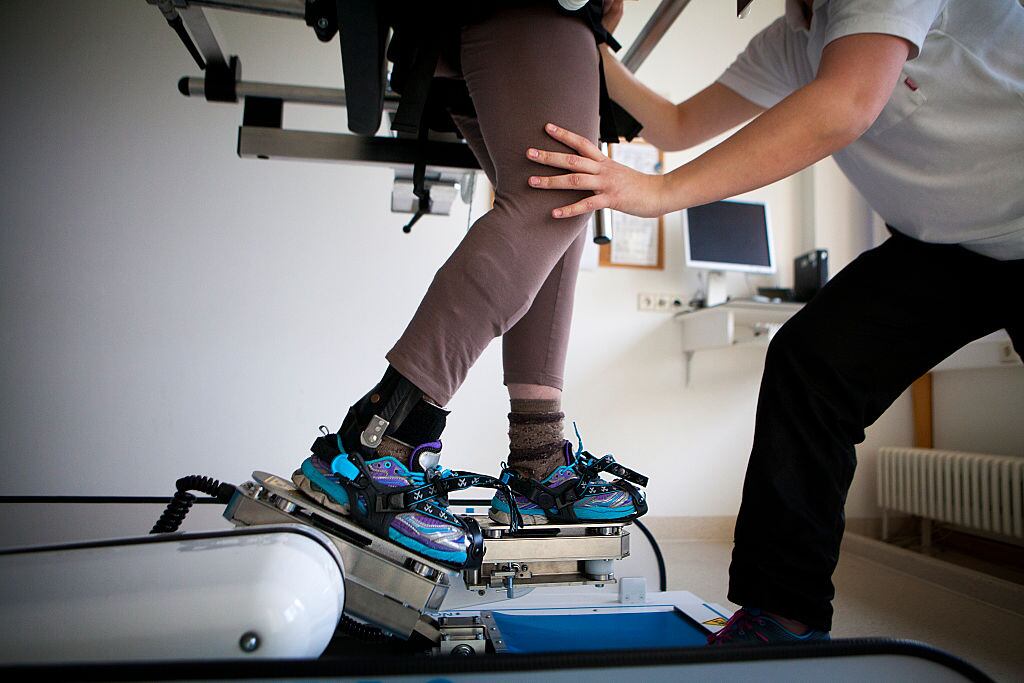 Reportage in a rehabilitation center in Germany, specializing in neurological rehabilitation after a stroke or head injury, equipped with robotic technologies to facilitate exercises. Patient suffering from a head injury uses the G-EO system that allows patients to practise walking again with the help of a physiotherapist. . (Photo by: BSIP/Universal Images Group via Getty Images)