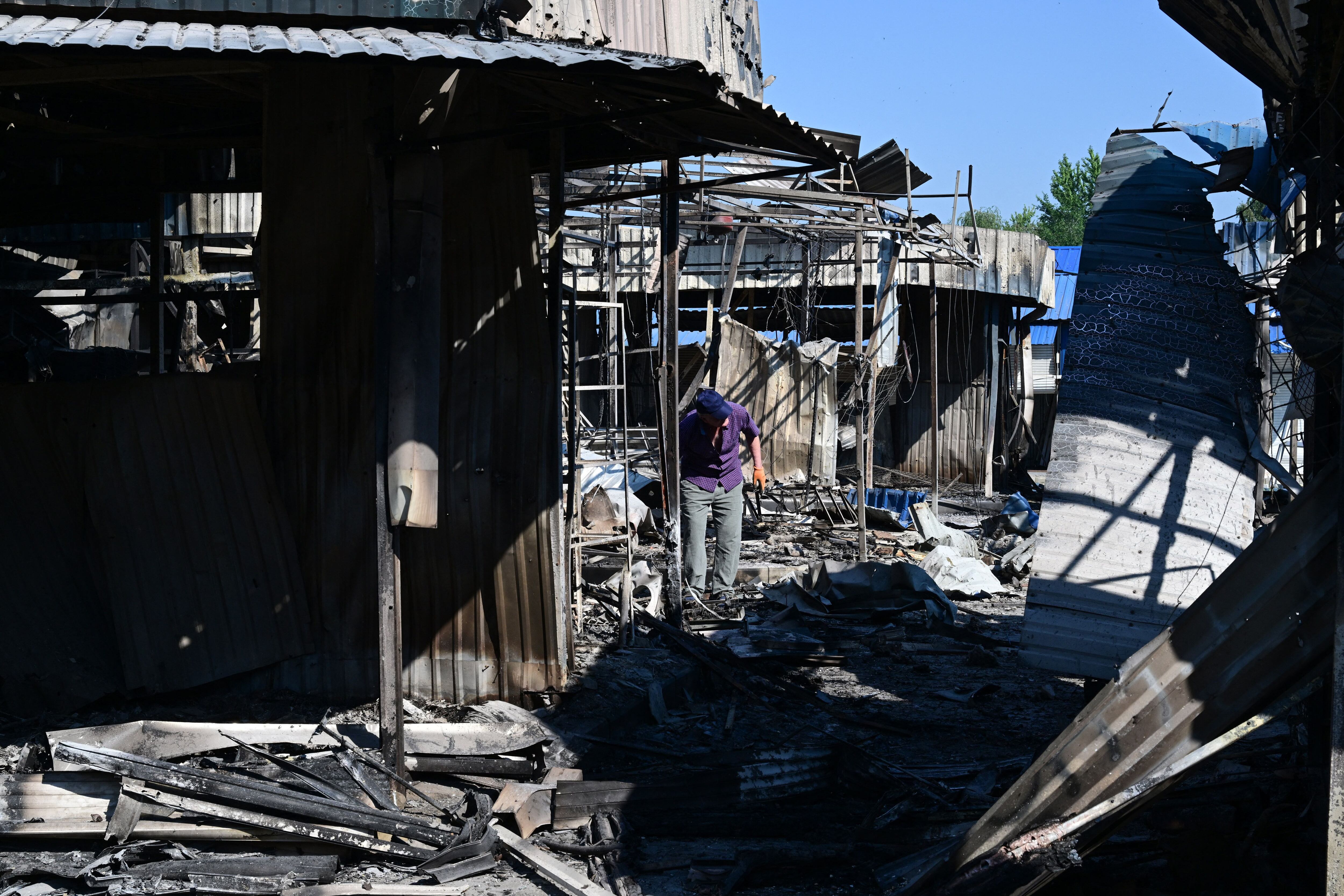 A man walks through the damage caused to the central market in Sloviansk by a suspected missile attack, on July 6, 2022, amid the Russian invasion of Ukraine. (Photo by MIGUEL MEDINA / AFP) (Photo by MIGUEL MEDINA/AFP via Getty Images)