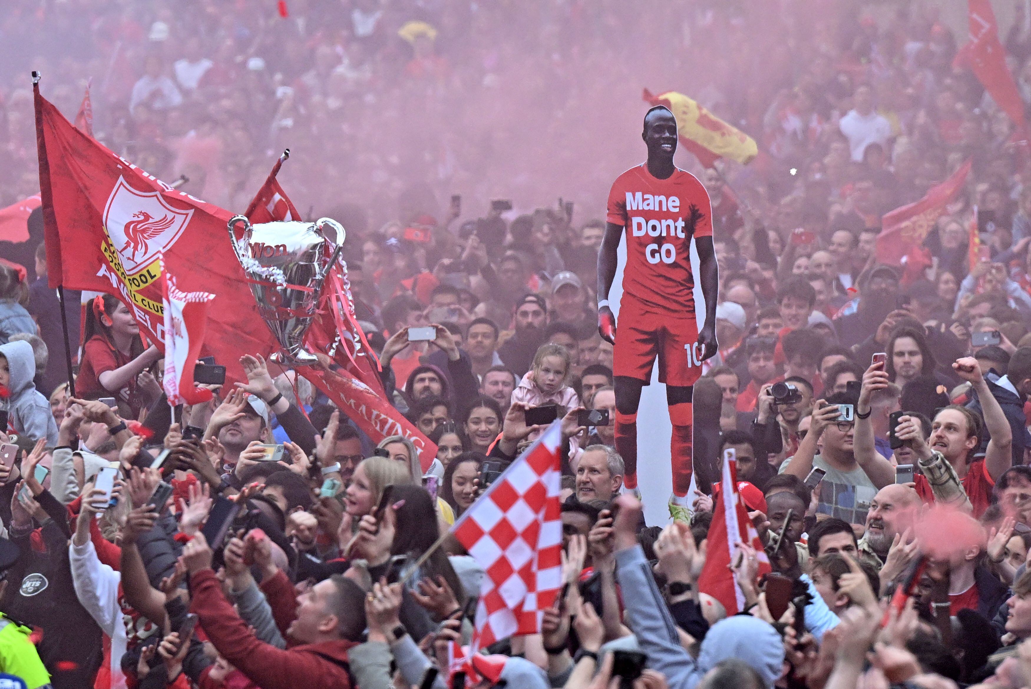 Liverpool's supporters cheer as Liverpool's open-top bus parades through the streets of Liverpool in north-west England on May 29, 2022, to celebrate winning the 2021-22 League Cup and FA Cup. (Photo by Oli SCARFF / AFP) (Photo by OLI SCARFF/AFP via Getty Images)
