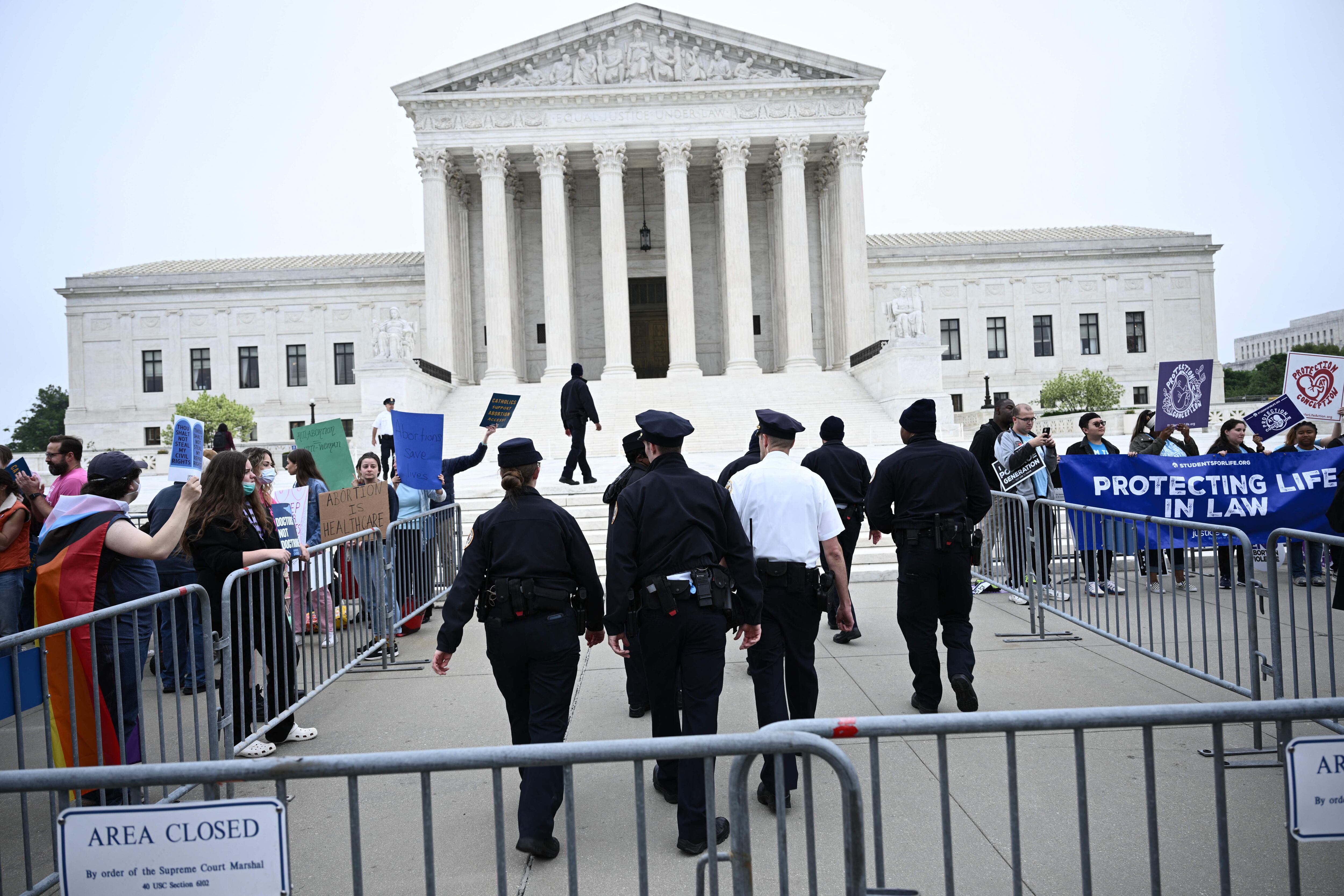 Pro-life and pro-choice demonstrators gather in front of the US Supreme Court in Washington, DC, on May 3, 2022. - The Supreme Court is poised to strike down the right to abortion in the US, according to a leaked draft of a majority opinion that would shred nearly 50 years of constitutional protections. The draft, obtained by Politico, was written by Justice Samuel Alito, and has been circulated inside the conservative-dominated court, the news outlet reported. Politico stressed that the document it obtained is a draft and opinions could change. The court is expected to issue a decision by June. The draft opinion calls the landmark 1973 Roe v Wade decision "egregiously wrong from the start." (Photo by Brendan SMIALOWSKI / AFP) (Photo by BRENDAN SMIALOWSKI/AFP via Getty Images)