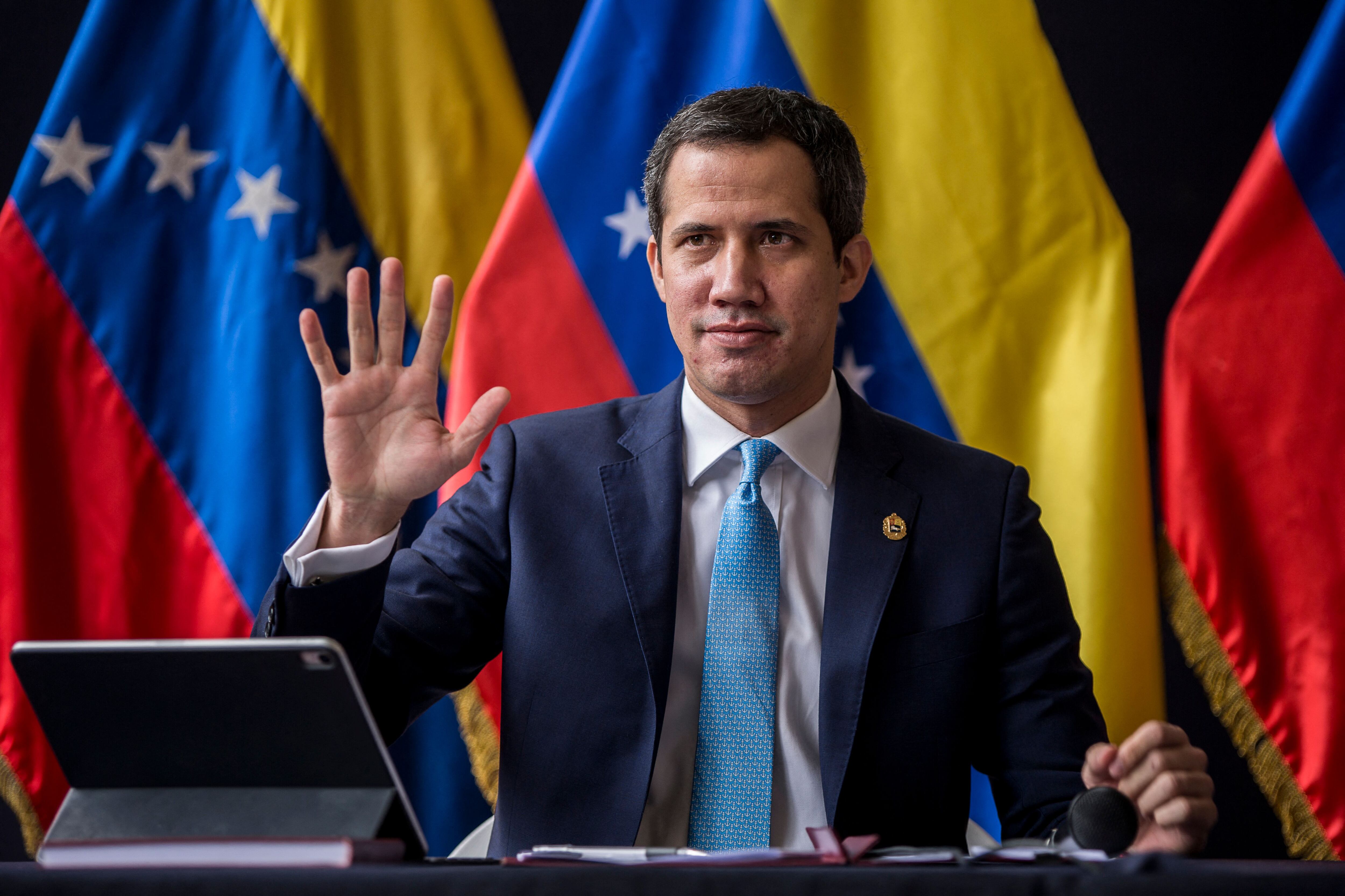 Venezuelan opposition leader Juan Guaido gestures during the installation of the National Parliament for the legislative period 2022-2023, which he presides, in Caracas, on January 5, 2022. - Opposition leader Juan Guaido was ratified on Monday January 3 by the fractured opposition as "in charge of the presidency" of Venezuela, a figure that the leader adopted in 2019 with international support to try to displace from power, unsuccessfully, the socialist President Nicolas Maduro. (Photo by Pedro Rances Mattey / AFP) (Photo by PEDRO RANCES MATTEY/AFP via Getty Images)