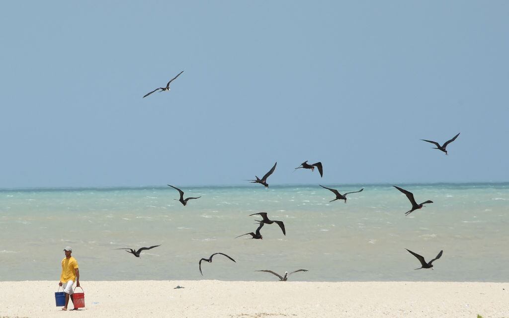 A fisherman leaves the Caribbean Sea at the Jasai beach in Riohacha, Colombia, on March 18, 2022. (Photo by DANIEL MUNOZ / AFP) (Photo by DANIEL MUNOZ/AFP via Getty Images)