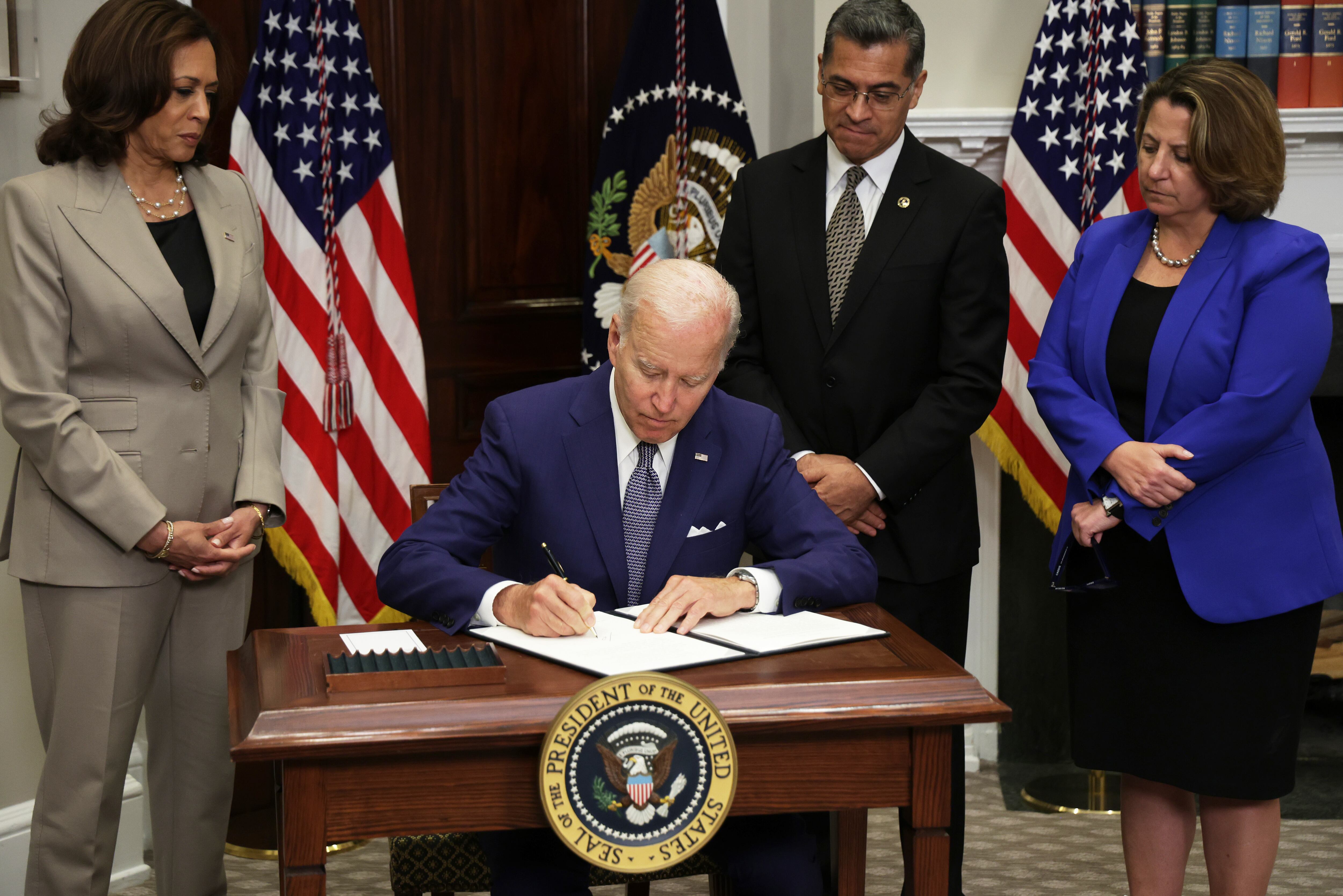 WASHINGTON, DC - JULY 08: U.S. President Joe Biden signs an executive order on access to reproductive health care services as (L-R) Vice President Kamala Harris, Secretary of Health and Human Services Xavier Becerra, and Deputy Attorney General Lisa Monaco look on during an event at the Roosevelt Room of the White House on July 8, 2022 in Washington, DC. President Biden delivered remarks on reproductive rights at the event. (Photo by Alex Wong/Getty Images)