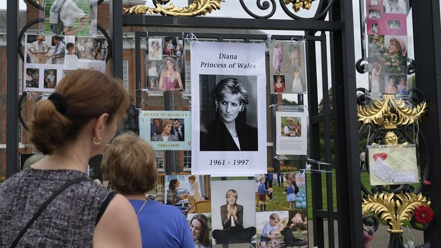 Turistas observan homenajes y recuerdos de la difunta Diana, princesa de Gales, colocados afuera del Palacio de Kensington en Londres. Foto: Associated Press - AP